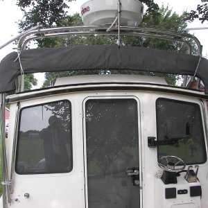 Camper top lashed to radar arch and grab rails for heavy fishing action.