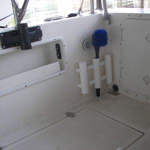 Both sides of cockpit have the heavy duty black holding tube with double plier holder slots, three tube rod/net/mop holder which can hold strap for cooler holding. The Black net holder tube allows you to bunjie the canvas top back, releasing the aft supports and allowing better fishing access while protecting the cabin door from rain.