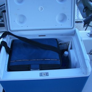 Cooler in Portable Fridge for one or two ppl. Only plug in when engine running or shore power, but extends ice life and easy to take ketchup, mayonnaise, cheese, milk back home in shoulder strap cooler.