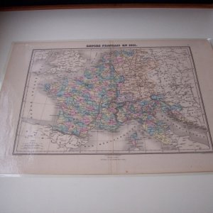 Laminated antique map of France from the height of Napoleon's reign.  Printed in 1872 depicting France in 1811.  I also had a custom piece of glass cut to fit inside the table fiddles to protect the map.