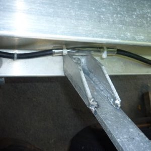 struts back in place with gussets, added tubing to protect brake line from rubbing on new gusset