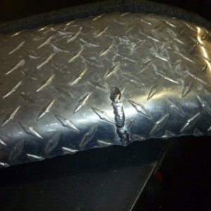 Float -On trailer's extremely thin aluminum fender we climb into the boat using this fender and it's rear support