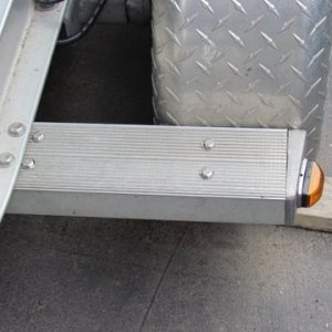 stainless steel bolt heads on the fender support show plate bolted in underneath step all the way thru and bolted to the trailers frame