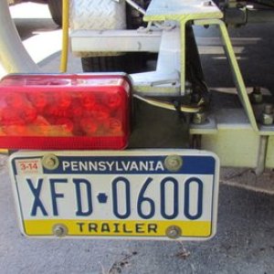 Rear view this should never break Used a 10.5" square piece of multiply conveyor belt. It can be cut with a sharp razor knife. Use over sized drill bits for holes when drilling the belt material. 30k + plus miles this is our original license plate.