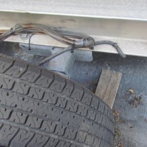 Media 'Note brake hoses sleeved in clear plastic tubing and tie wrapped to prevent rub through.' in album 'P1000486 Some scrap 3 x 4" aluminum angle 1/2" stainless u-bolt 35 dollar stainless turnbuckle, short piece of chain, and a shackle.'