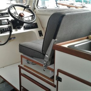 Media 'Raised helm seat for more storage and better view.  It is removable with 2 lock downs to provide extra counter space.  Removable helm foot rest give additional storage as well.' in album 'Using fishing pole mounts for custom stern Line roller allows you to store roller out of the way when not fishing'