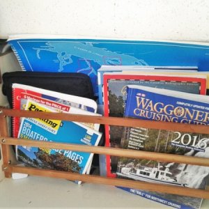 Media 'Under table Chart Book & Cruising Guide storage' in album 'Using fishing pole mounts for custom stern Line roller allows you to store roller out of the way when not fishing'