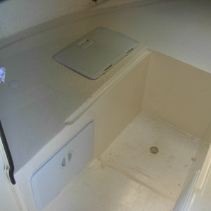 I hollowed out the foam from under the V berth.  I entered froml the side first, and found that it was almost impossible to work in there, so I then entered from the top.  Glad I did both.  Used Tempress hatches.  The first set were "slam" catchs, and due to the very slight curved of the wall, they would not stay closed.  So they ended up on top, and "cam" latches on the vertical sides.