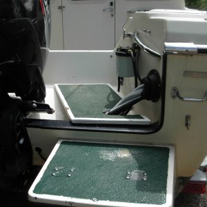 Media '"Bridge over the splash-well from the swim step to the cockpit of boat.  3/4" plywood, epoxied & painted.  Green paint has sharp silica sand for traction.  Bridge must be kept slid to outside when boating.  You can see crunch on white edge where hydrolic steering arm crunched it when it moved too far to the center of the boat.  Note large "Sierra" fuel filter.  Filter which came with boat gave problems and left me to be towed in one time.  I replaced the original filter with this inexpensive one that still filters out water.  I replace filter canister yearly and no problem for last 6 years.' in album 'I hollowed out the foam from under the V berth.  I entered froml the side first, and found that it was almost impossible to work in there, so I then entered from the top.  Glad I did both.  Used Tempress hatches.  The first set were "slam" catchs, and due to the very slight curved of the wall, they would not stay closed.  So they ended up on top, and "cam" latches on the vertical sides.'