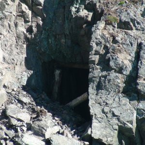 Old mine shaft on lake edge of Lewellyn Inlet