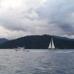(seabran) We crossed the Straight of Georgia with Bambina and Anita Marie. Here Anita Marie is blowing past a sailboat as we head for Roscoe Bay. Notice the dark clouds?