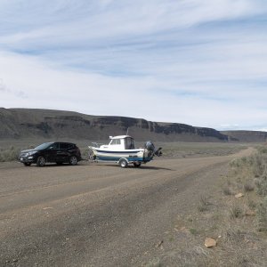 I now have more than 2K miles on the trailer, some on steep gravel roads, and I have never felt the trailer push on me when stopping.  I can hardly even tell that it's there.  Except the bouncing on roads like this.