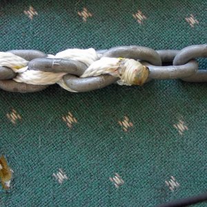 Chain/Rope Splice: Ends of two strands are sewn toigether and whipped/fused with heat.  Butt end is pulled down into space beweeen links after tension is applied.