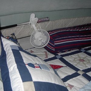 Small fan by bed cools great at night.  This also is 120-v, but I can also run it off an inverter when needed to keep the generator noise down.