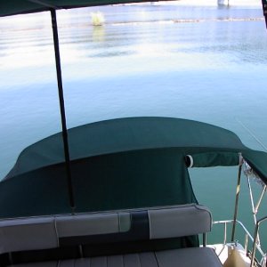 Aft view from helm. Cockpit has entire closure. Flying bridge has bimini and side curtains.