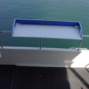 Magma stove table mounted in center of cockpit rear rail. Doubles as fish cleaning table.