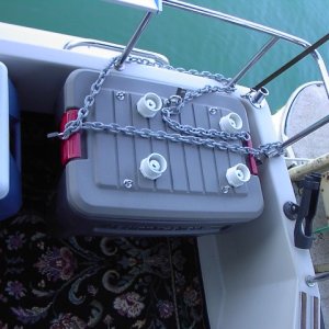 Box has four padlocks and 10 feet of 1/4" GS-40 High Test chain. The chain can lock the box down to anything solid  for storage, and can also lock the generator and box down together with the generator on top running.