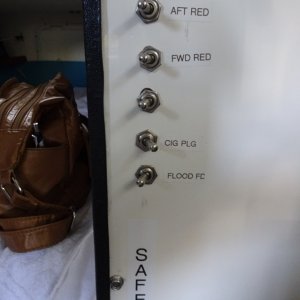 Auto pilot with two switches above, Toggle switches can be reached from the bunk and turn on red lights, the Sirius (Cig plug and a flood light which illuminates the foredeck and for docking.