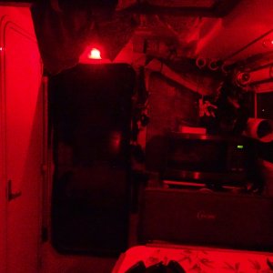 Media 'Looking aft, red lights above door, and in the light fixture over the aft dinette seat (white there for reading also)   One of the two cabin door screens is in place.' in album 'Galley counter and back storage'