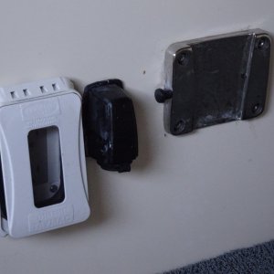 from outboard: water resistant 110 v plug for freezer, 12 volt plug for freezer and holder for cockpit table.