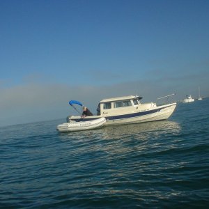 Jim on Pounder at end of return trip securing his towed dingey for docking at MDR