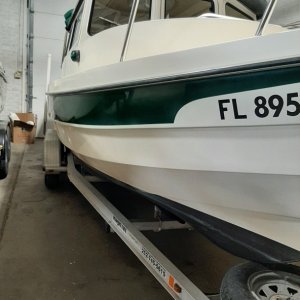 Home in Winter storage Wilson, NY.  My marina guys did an awesome job restoring gel coat and forest green stripe.