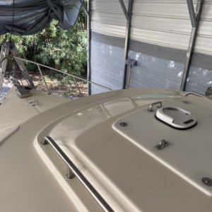 Covered previous holes with large starboard after filling and redrilling holes and rebedding handrails with 5200 to correct cabin roof leaks