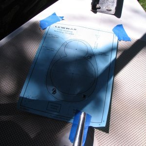 template taped down to mark hole locations