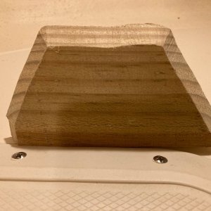a shim of treated wood raised the bottom of the locker to at least the level of the drain