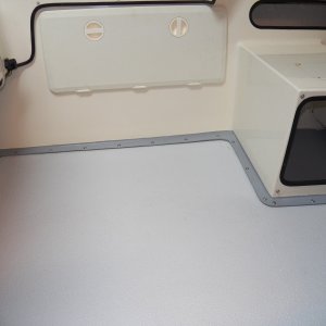 Reinstalled with stainless screws and finish washers to replace the silly steel and aluminum pop rivets that caused the balsa core damage.