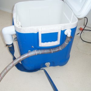 The supply hose. The flat blue hose is the drain. It slips into the cockpit drain in the back corner. The supply hose is filled from the raw water wash down, via a hose "Y".