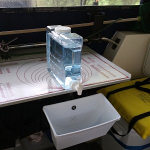 Our simple sink that rotates back under the table when not in use