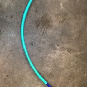 The gentleman's discreet solution to avoiding excess liquid in the enclosed head.  The hose goes out through the splashwell drain hole and the funnel is inside the bimini enclosure.  Works extremely well.