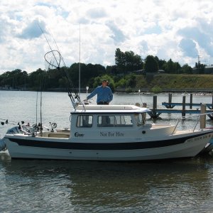 (Not For Hire) Boat at dock using rocket launchers and rod holders on transom board.