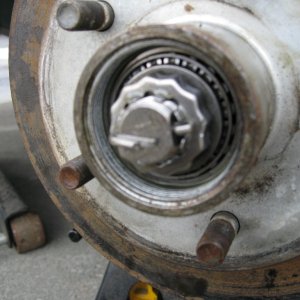 Media 'Tighten the wheel bold tells it?s good and snug, than back it off about 1/8th to 1/4th turn.
Install lock ring and a new cotter pin.' in album 'Make sure you have placed a jack stand on each axel.  If your trailer is duel axel only remove one wheel at a time, this provides a higher level of safety.'