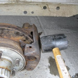 Media 'Tap the rusty hideous looking caliper and pads back in place; next year I?ll put on some new pads.  Run in the caliper bolts and you?re done.' in album 'Make sure you have placed a jack stand on each axel.  If your trailer is duel axel only remove one wheel at a time, this provides a higher level of safety.'