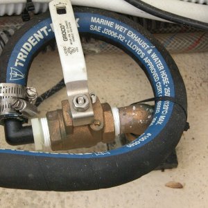 Media 'Sea Angel air conditioning system seacock with its white handle in the closed position.' in album 'Sea Angel view under step entering cabin. The base of the step(kick plate) is sealed to prevent any water from entering the cabin floor area under the 'dry deck'.'