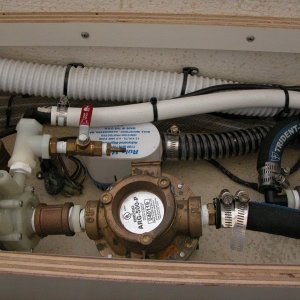 Sea Angel air conditioning plumbing with its raw water strainer, water pump,bleeder valve and white supply line to the condenser coil assy. The RULE bilge pump is for the shower drain and also as a secondary to the main.