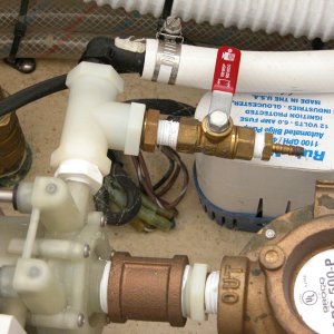 Media 'A closer look at Sea Angel's air conditioner water pump bleeder valve with its red handle closed. The circulation pump needs to be primed to work. It does not have to have power to be primed, if in the water. It is below the water line. Just open the bleeder valve to prime, then close to operate the A/C.' in album 'Sea Angel view under step entering cabin. The base of the step(kick plate) is sealed to prevent any water from entering the cabin floor area under the 'dry deck'.'