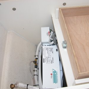 Media 'AC is located under mate's seat. The "T" in the cooling line is to drain the drip pan of any condensation buildup.' in album 'Sea Angel view under step entering cabin. The base of the step(kick plate) is sealed to prevent any water from entering the cabin floor area under the 'dry deck'.'