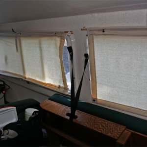 Media 'Starbard Window Covers Down make a soft light' in album 'Copilot storage made from lucite sheet cut, heated and formed into a simple L shape. Mounted to forward bulkhead and seat box. Teak trim stiffens and covers the top edge.'