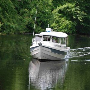 Media 'Steve and Joan of OSPREY approaches the dock under the watchful eye of grandson, Henry, at the mate's seat.' in album 'Where could that C-Dory flotilla be, the dock is empty?? UGH, too early.'