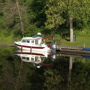 Media 'eay cruising on the Rideau' in album 'a boat coming into a dock while we are waiting to go the other way.  Notice the straps on the walls that you tie up to to secure the boat when the water comes in or goes out.'