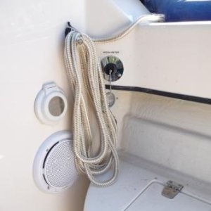 2. -Spring Line Storage. 
-Fresh water male discharge outlet. I use this to empty the fresh water tank of stale water or when cleaning the porta potti while under way.
-Shore power access plug.
-Cockpit stereo speaker.
Cockpit light.