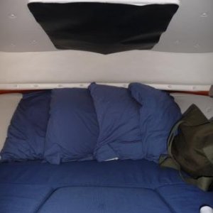 12.  Black canvas sign material cut to size and attached with "Velcro" to darken sleeping area in the day light and give better privacy at night with the light on, when tied next to a dock.