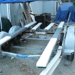 4x6x12' PT main bunks mounted just inside the outer edges of the 22' I have heard it is important that PT lumber NOT come in contact with aluminum. The bunks are covered with plastic slides though I left about 4' carpet only to get some friction.
There are two short plastic covered composite bunks that help support the transom weight. 2 keel rollers forward.