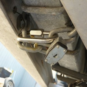 Underside how chain is attached to main trailer beam. Stainless screw on with dab of JB weld and padlock for security.