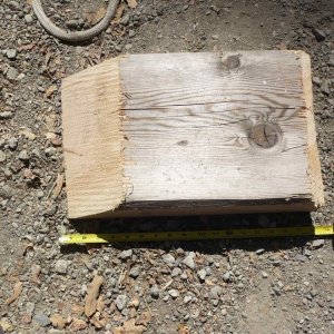 18" chunk of 4x12 (easily cut with chainsaw) makes a great drive on for changing a flat tire on a tandem. Doubles as chock. Considering driving a couple screws completely through the tapered edge so it will get a bite on pavement and not slide as easily on drive up. At 18" it will just fit between tires for forward drive on with any tire.

Other parts of the trailer travel box are: Fitting tire iron; 1 complete bearing/hub/seal kit; a second set/bearings only and races; spare bearing buddy and small grease gun; ir thermo; spare lights; tools for removing a hub; paper towels/orange gel/disposable rubber gloves; Small tarp to sit on; flares and safety reflector;trailer wiring circuit tester; chain/spare ratchet strap tie downs (for temp. emergency repairs). Please add other suggestions in comments.