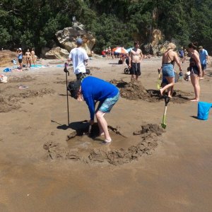 Media 'Here I am digging a hole in the sand (everybody brings a shovel).' in album 'We rented a cabin for a couple of days at Hot Water Beach.'