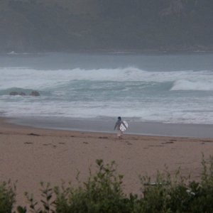 The tide comes in, the crowds disappear, and just a few remain.  Sitting on the front porch watching surfers is my kind of spectator sport.